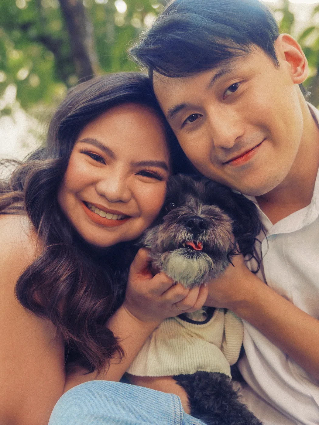 Cheek to cheek with their dog