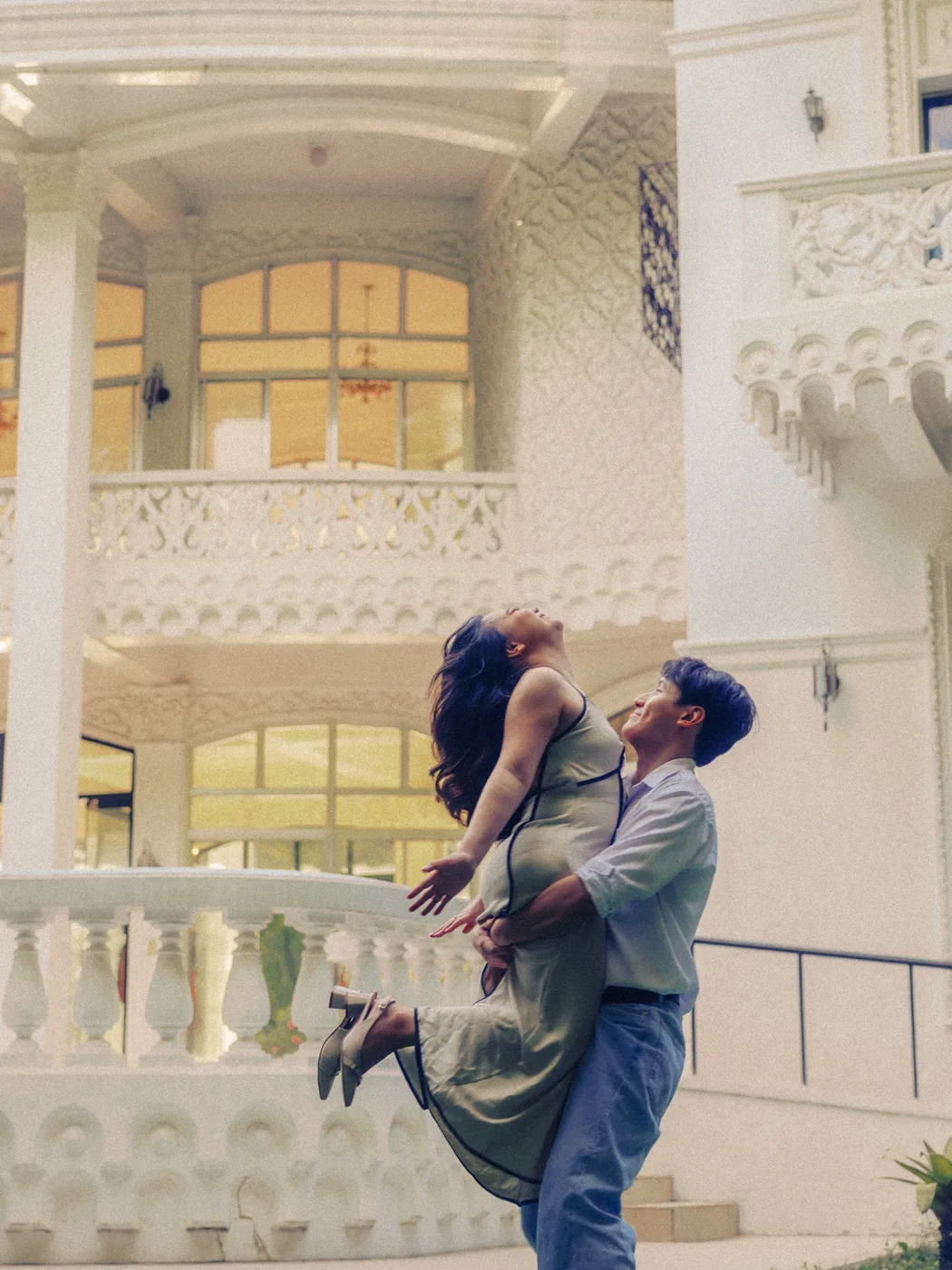 James lifting Elaine by the balustrade